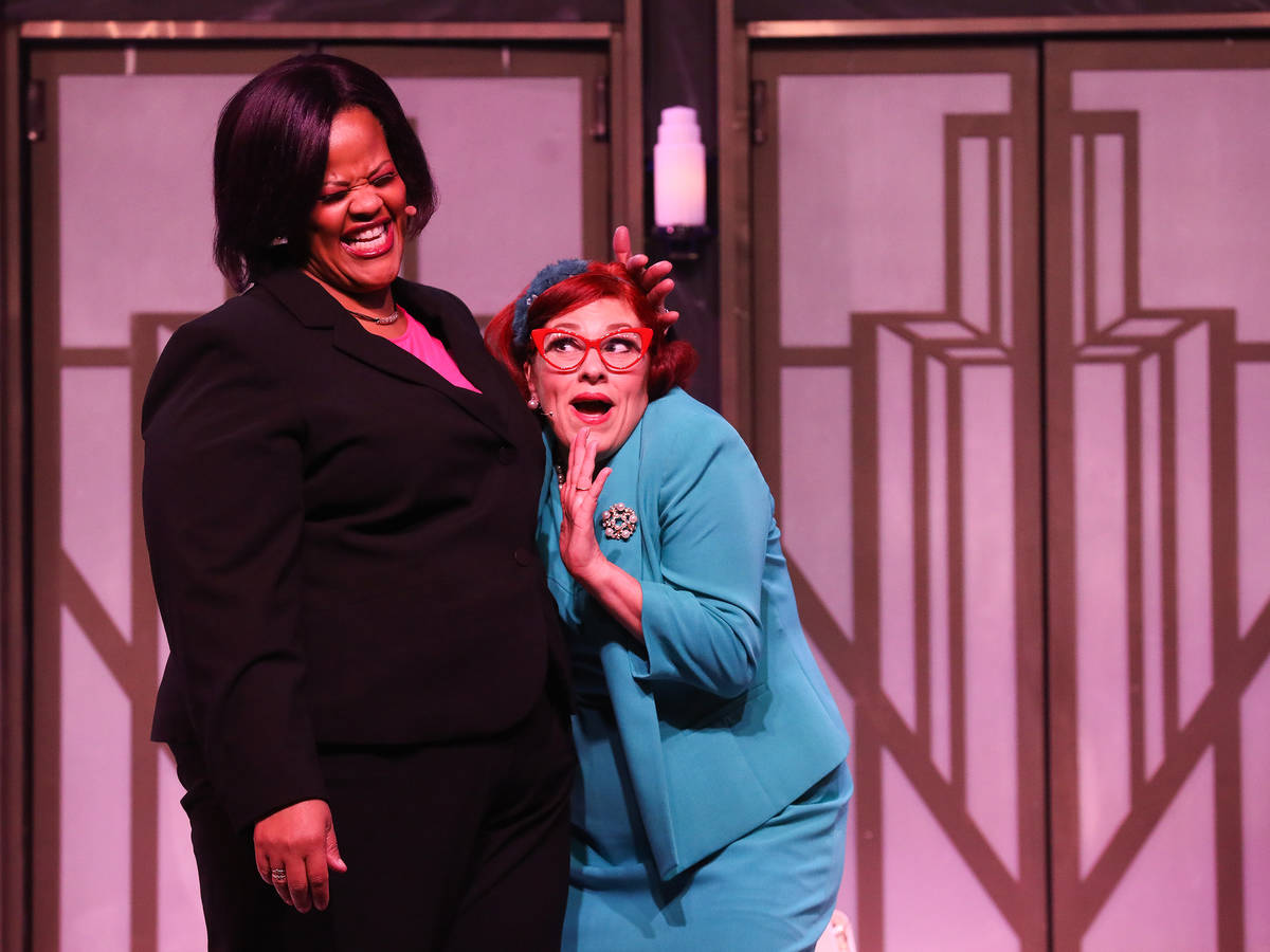 Lisa Mack performs as Professional Woman, left, and Cherity Harchis as Iowa Housewife during a ...