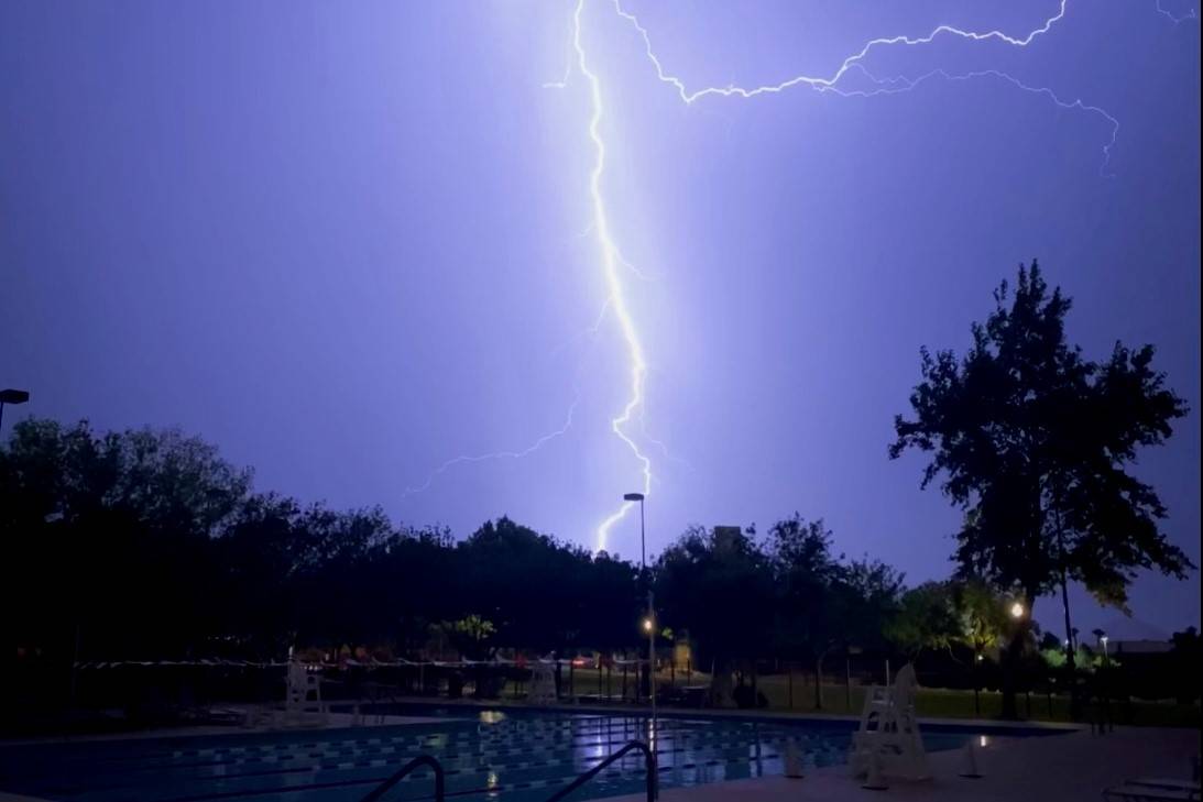 Lightning illuminates the sky above the Trails Pool in Summerlin on Tuesday, July 20, 2021. (Co ...