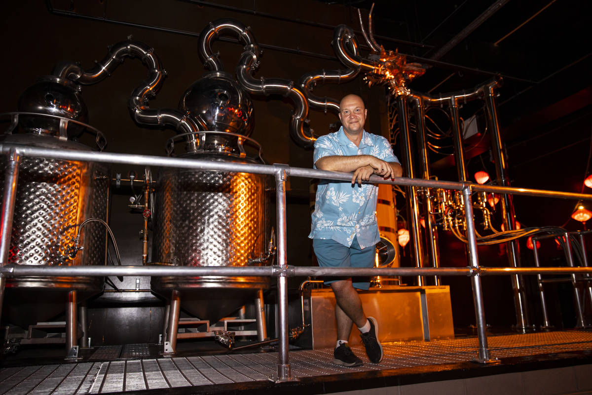 Bryan Davis, founder of Lost Spirits Distillery, poses for a portrait with his custom-built sti ...
