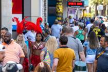 People walk along the Strip near The Venetian, most not wearing mask, on Friday, July 16, 2021, ...