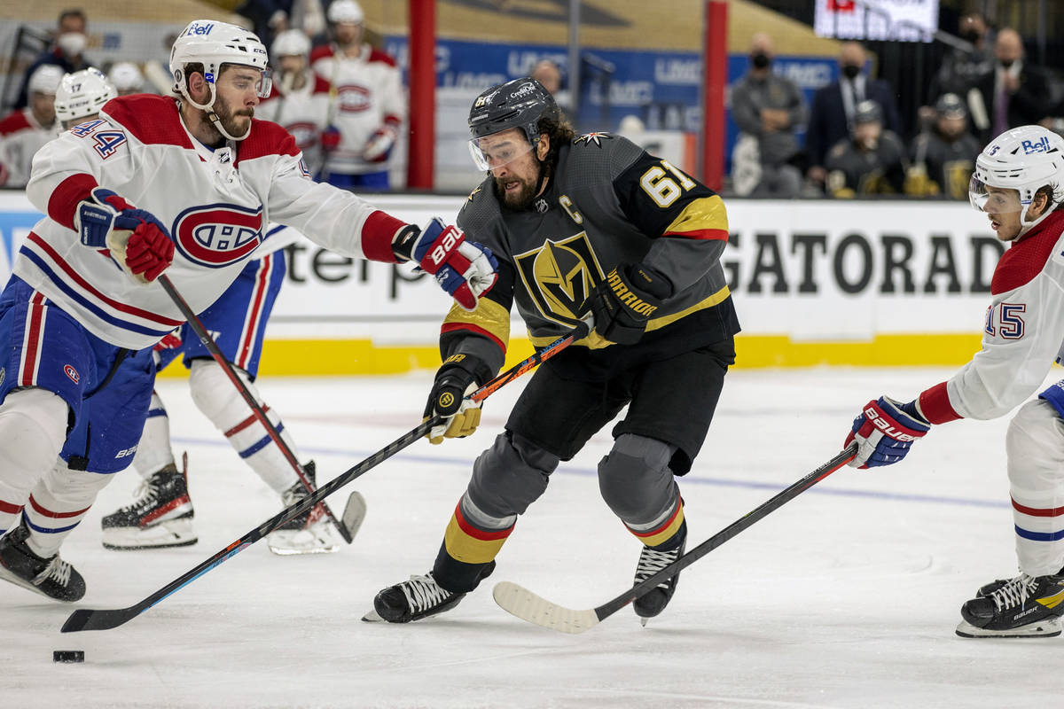 Golden Knights right wing Mark Stone (61) battles for control of the puck with Montreal Canadie ...
