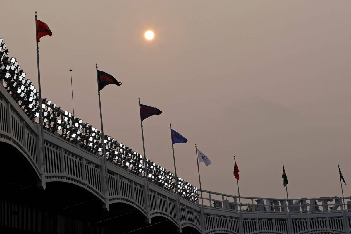 Smoke from Western wildfires dims the sun before the Philadelphia Phillies played New York Yank ...
