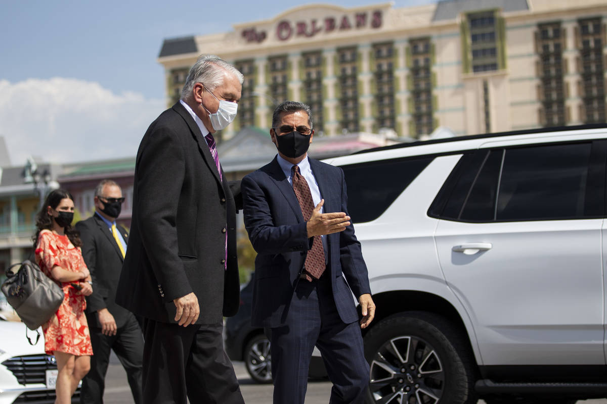 Nevada Governor Steve Sisolak, left, greets U.S. Health and Human Services Secretary Xavier Bec ...