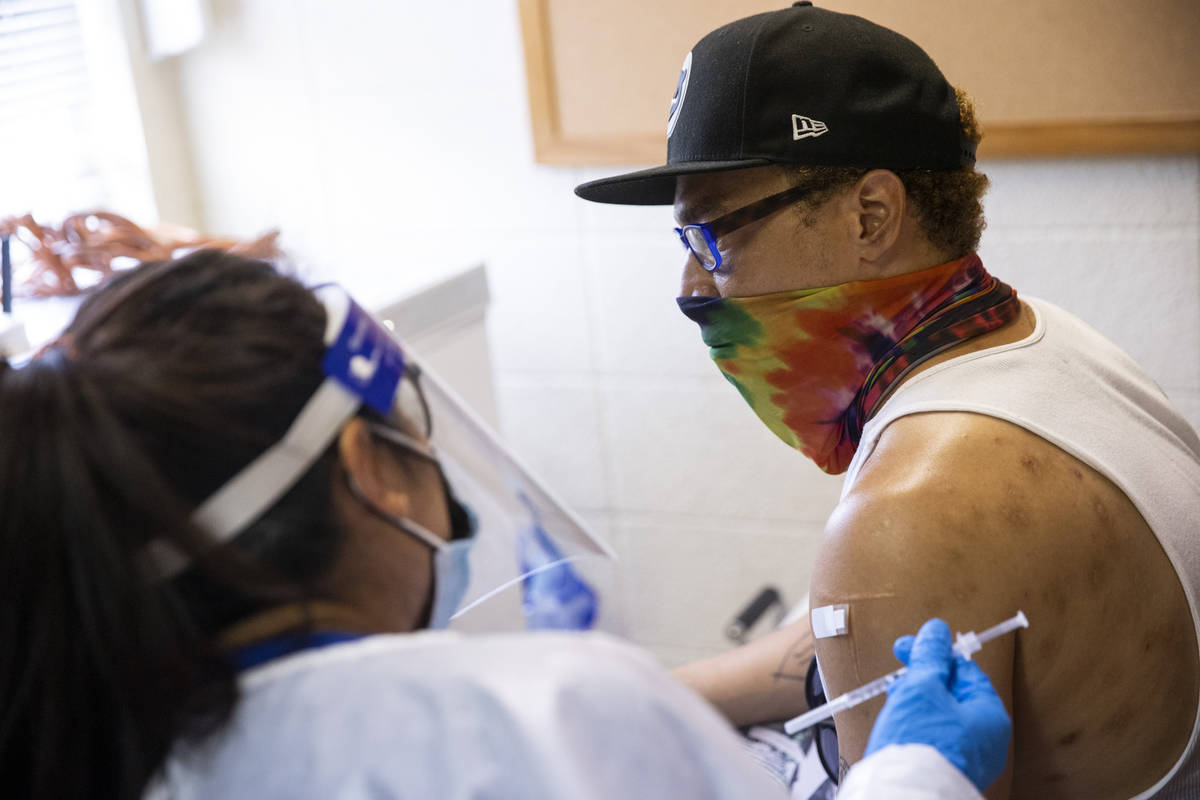 Dino Poston receives the COVID-19 vaccination at the Sherman Gardens Vaccination Clinic in Las ...