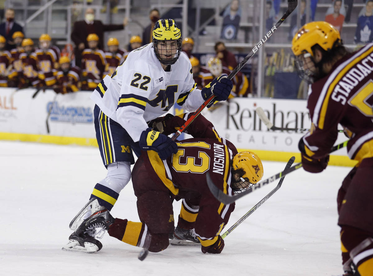 FILE - In this Dec. 8, 2020, file photo, Michigan's Owen Power (22) watches the puck while work ...