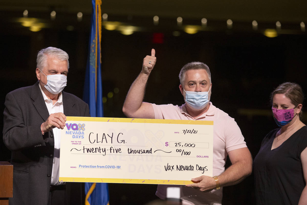 Gov. Steve Sisolak and Immunize Nevada present a check for $25,000 to Clay G. during the announ ...