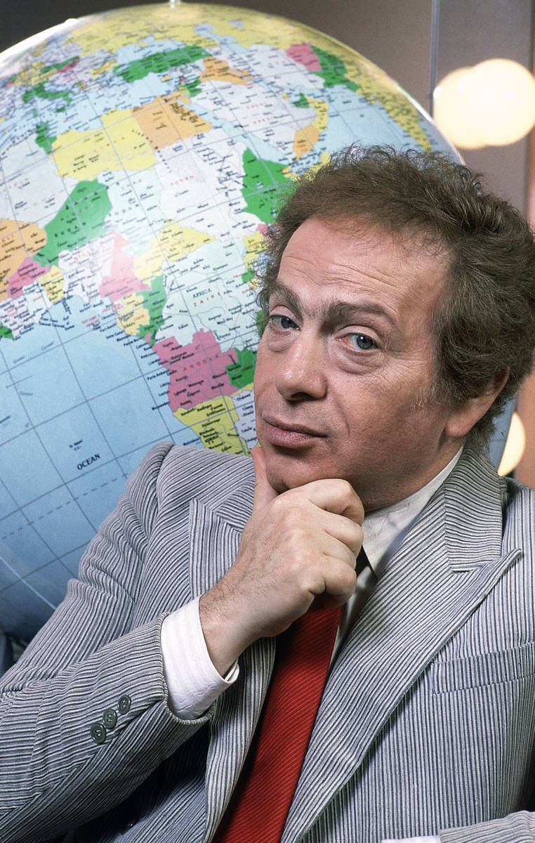 FILE - In this Jan. 27, 1987, file photo, Jackie Mason poses in his dressing with a globe as he ...