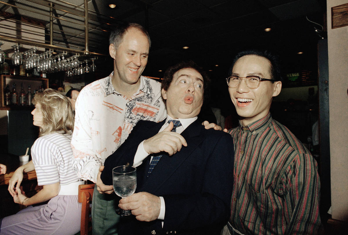FILE - In this July 21, 1988, file photo, comedian Jackie Mason, holding a glass, enjoys a jok ...