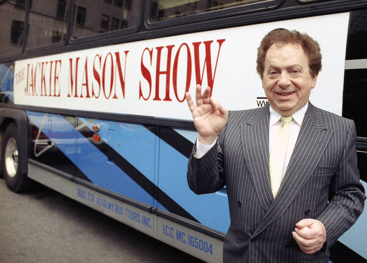 FILE - Actor/comedian Jackie Mason stands beside a bus displaying a sign advertising his TV sho ...