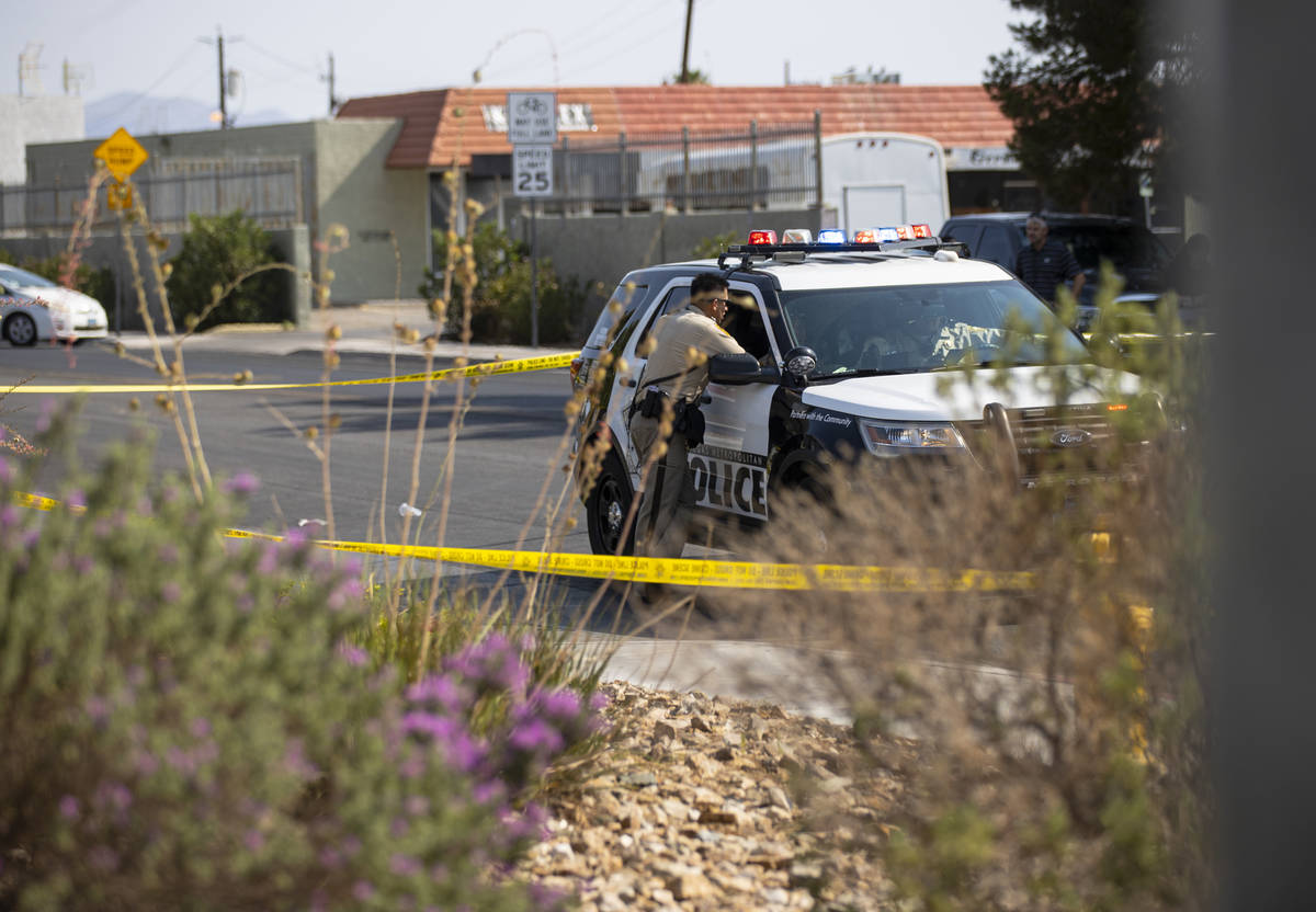 Las Vegas police, with the assistance of animal control, investigate the scene where a dog was ...