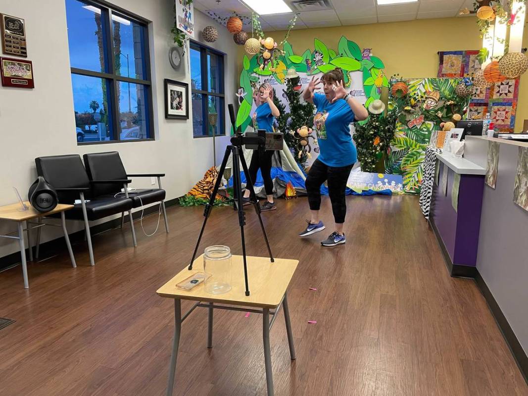 Volunteers dance during a livestream for Camp Cartwheel, an annual summer camp for children wit ...