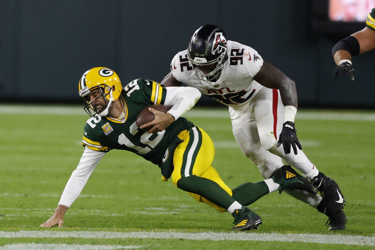 Green Bay Packers quarterback Aaron Rodgers (12) is tackled by Atlanta Falcons' Charles Harris ...