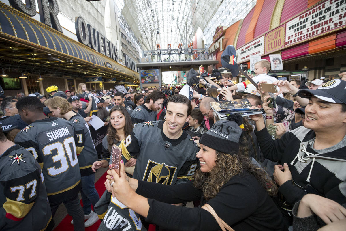 Golden Knights goaltender Marc-Andre Fleury (29) poses with a fan during the team's first fan f ...