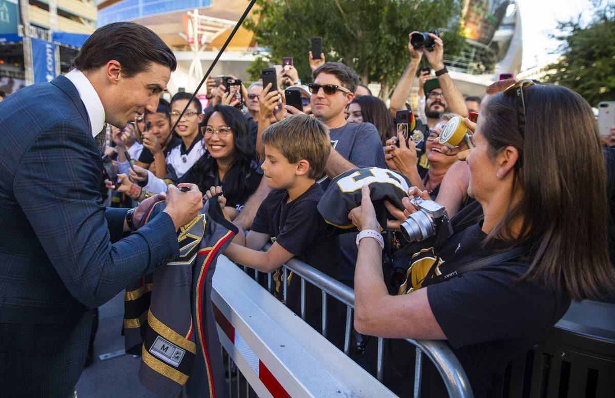 Golden Knights goaltender Marc-Andre Fleury signs an autograph for Lucas Lanfranchi, 9, while w ...