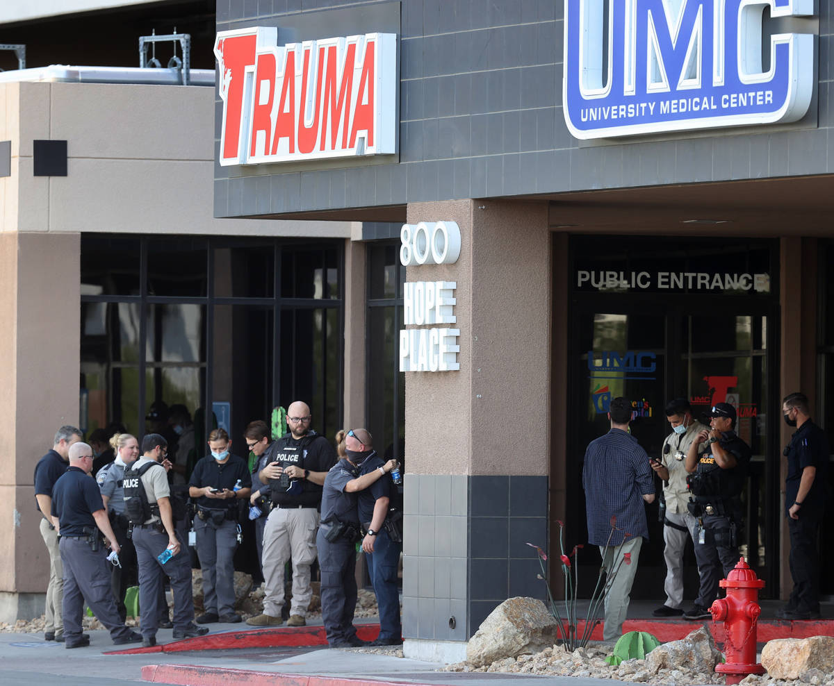 Police officers from multiple Las Vegas agencies and hospital personnel gather in front of Univ ...