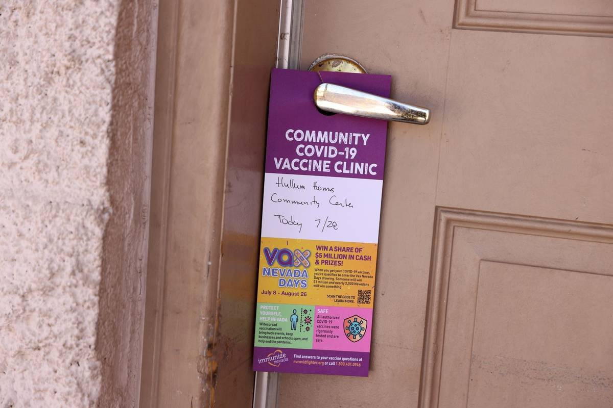 A door hanger announcing a FEMA surge team COVID-19 vaccination event at Hullum Homes public ho ...