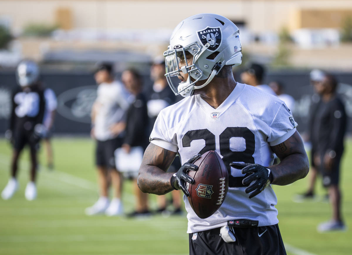 Raiders running back Josh Jacobs (28) with the ball during the Raiders training camp at the Int ...