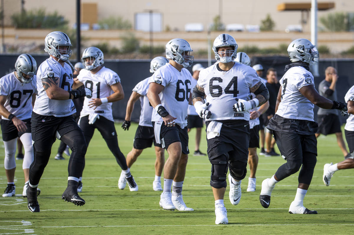 Raiders center Andre James (68) warms up with teammates during the Raiders training camp at the ...
