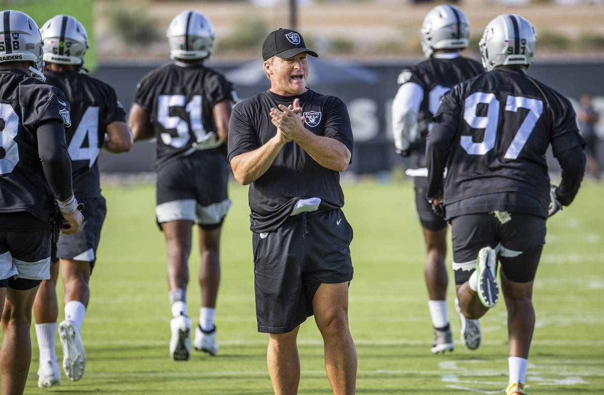 Raiders head coach Jon Gruden greets pumps up his players during the Raiders training camp at t ...