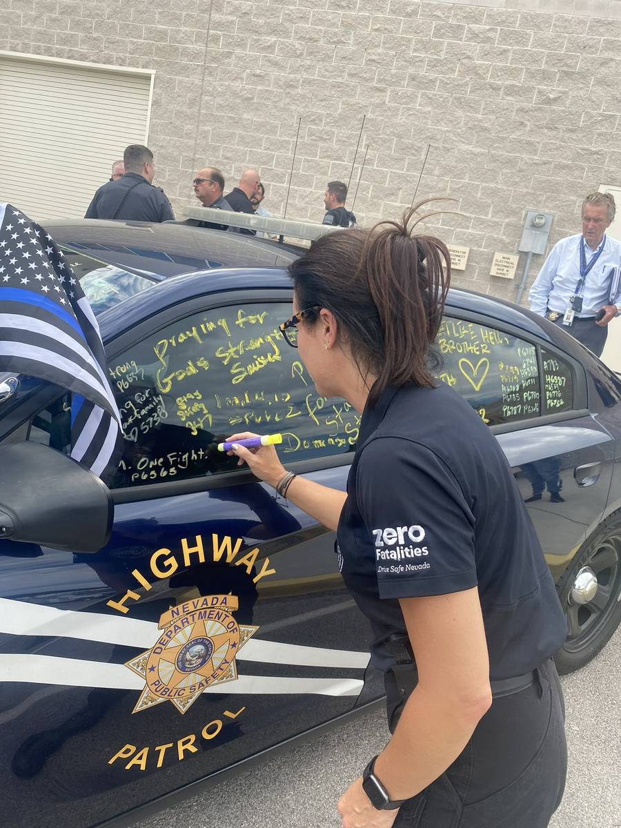 Members of the Nevada Department of Public Safety signed the patrol car of critically injured t ...