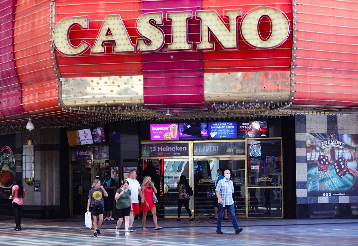 Visitors walk past the Fremont Casino at the Fremont Street Experience in Downtown Las Vegas We ...