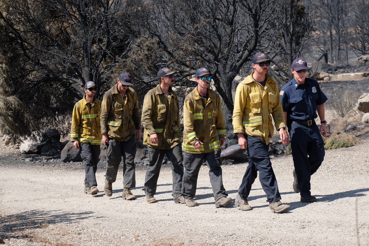 A few of the 1,300 firefighters assigned to containment efforts on 68,000 acre Tamarack Fire. J ...