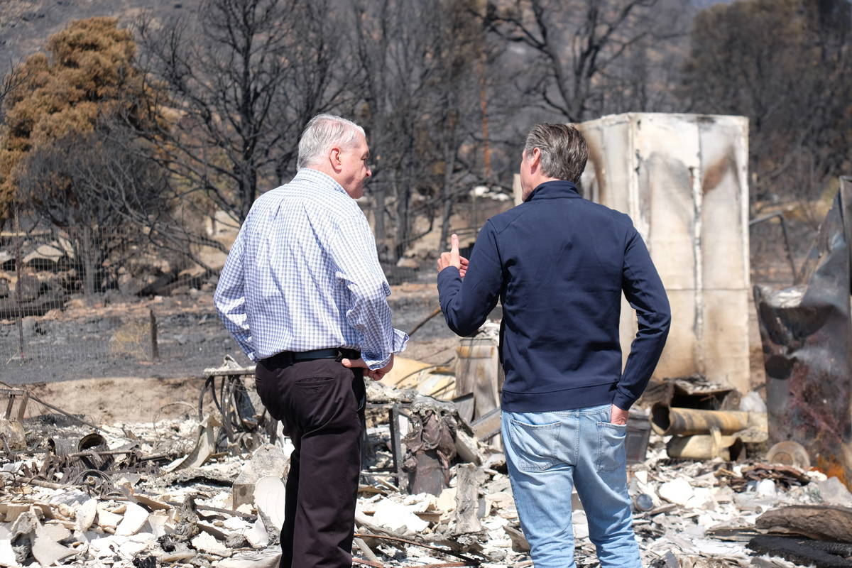 Govs. Sisolak and Newsom look over remains of a home destroyed by fire. July 28, 2021. (Bill De ...