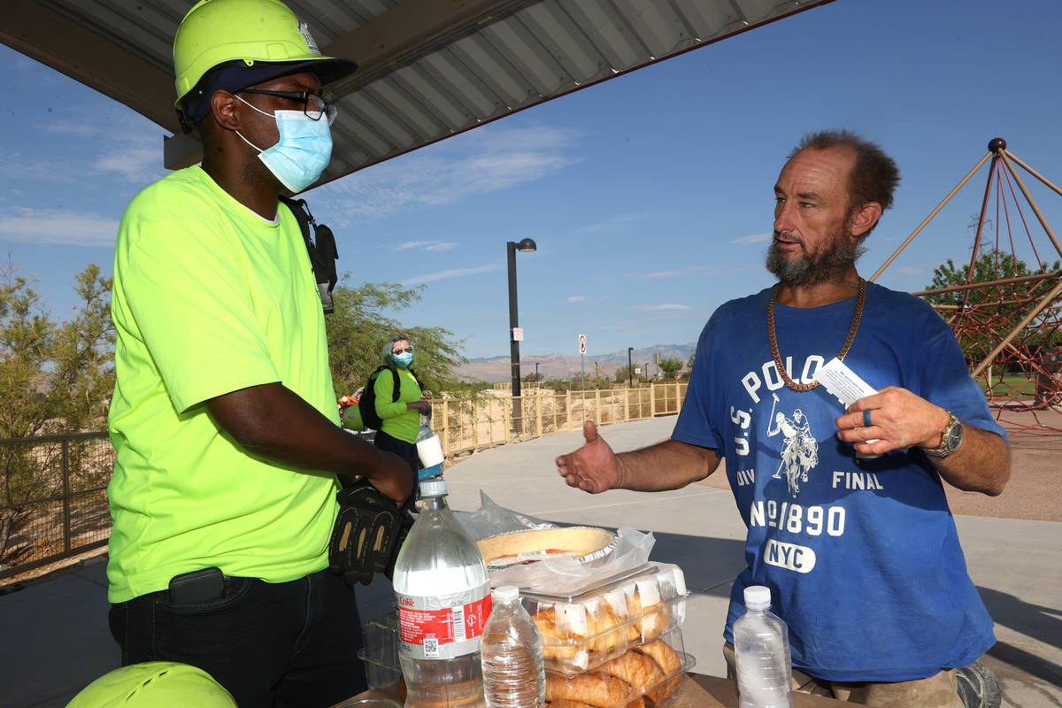 HELP of Southern Nevada outreach worker Eugene Wallace, left, interviews Carl Nickels, 44, duri ...