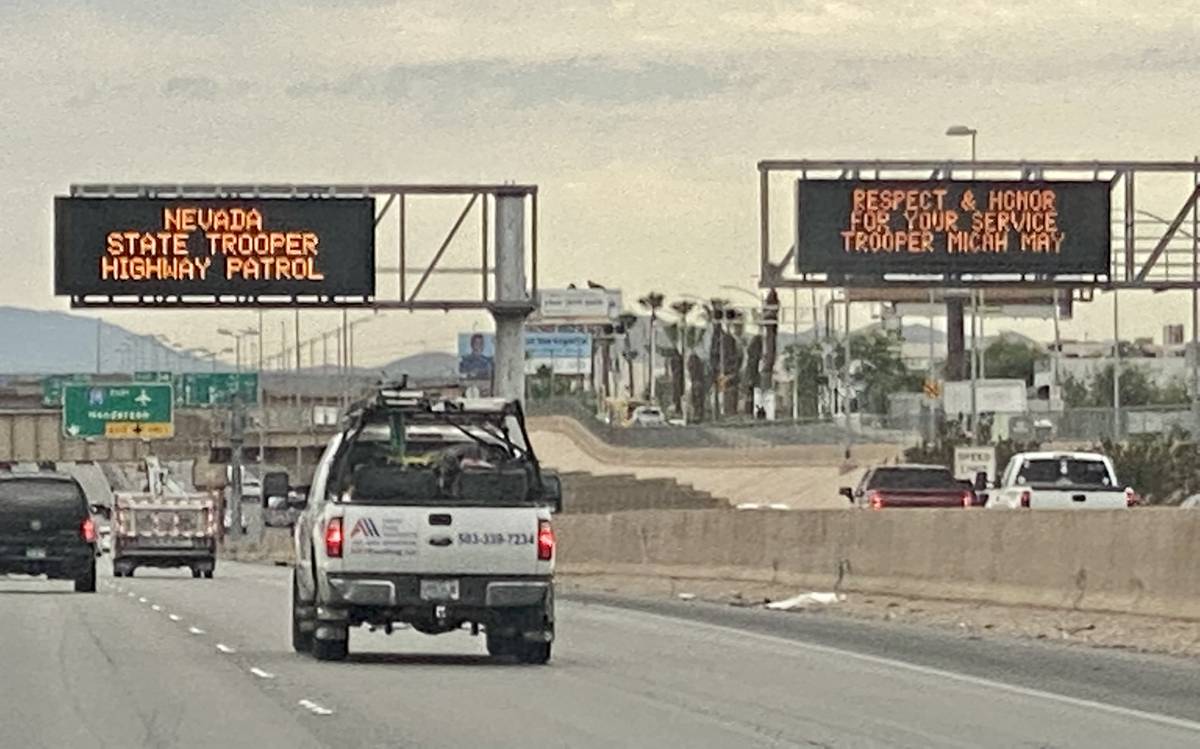 Two signs for Nevada Highway Patrol trooper Micah May are seen on southbound Interstate 15 in L ...