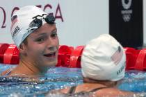 Katie Grimes, left, of the United States, talks with teammate Katie Ledecky, following their he ...