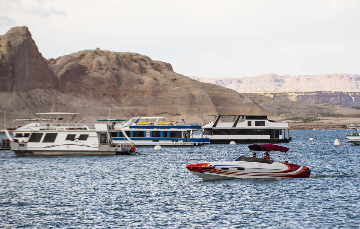 Boats are pictured near the Wahweap Marina at Lake Powell in the Glen Canyon National Recreatio ...