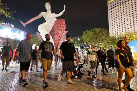 People, nearly all without masks, walk near T-Mobile Arena, on Saturday, July 10, 2021, in Las ...