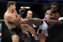 Paulo Costa, left, and Uriah Hall exchange kicks in the middleweight bout during UFC 226 at T-M ...