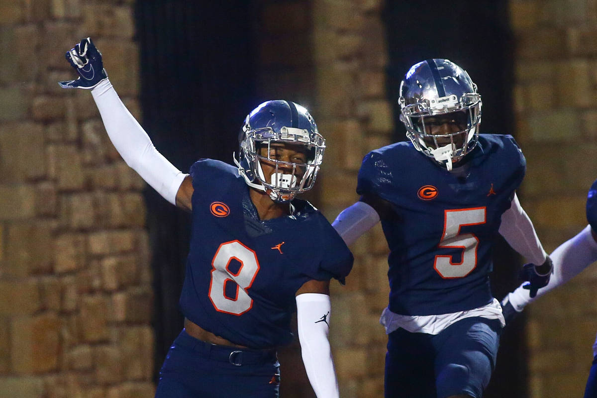 Bishop Gorman's Fabian Ross (8) celebrates his touchdown with teammates during the first half o ...