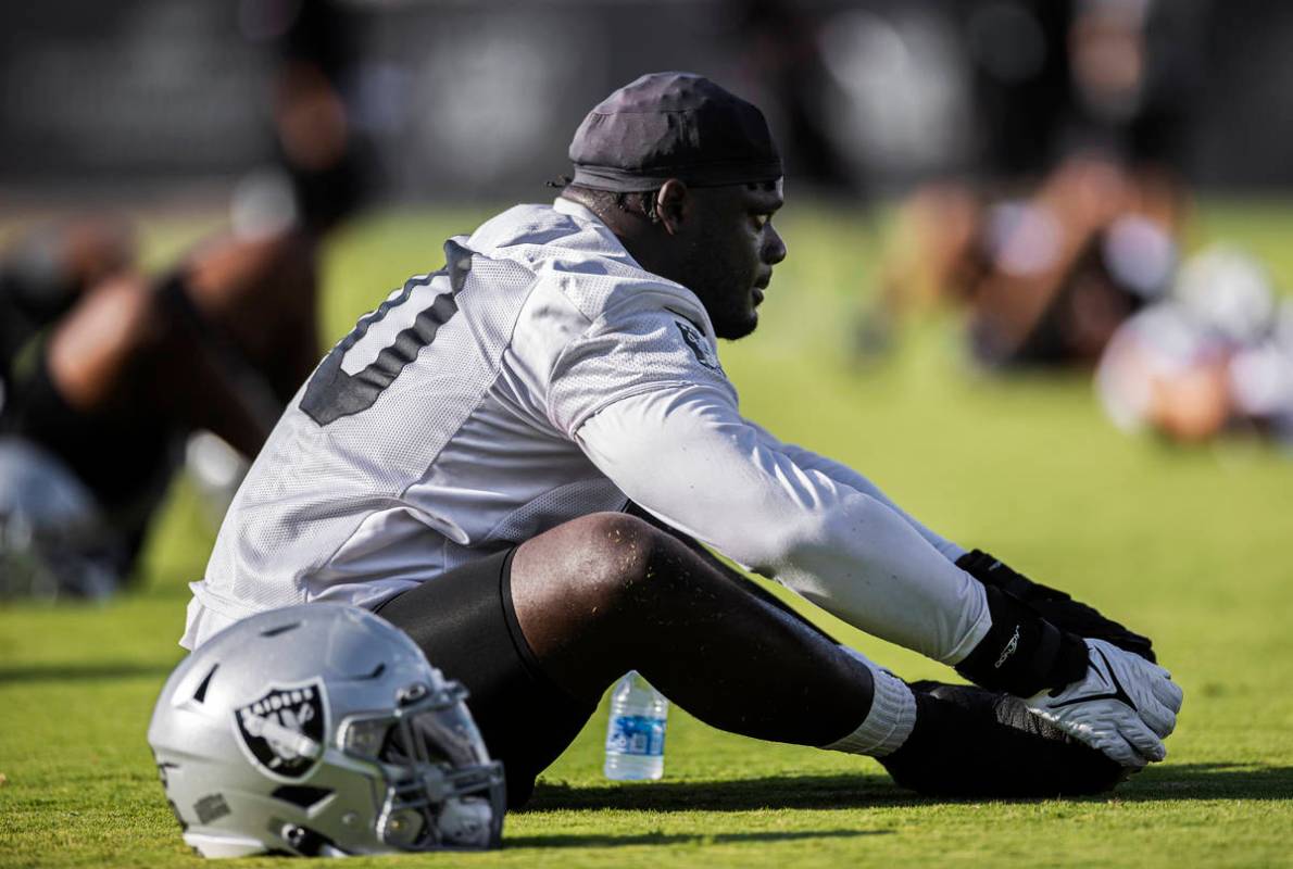 Raiders offensive tackle Alex Leatherwood (70) stretches during training camp on Saturday, July ...