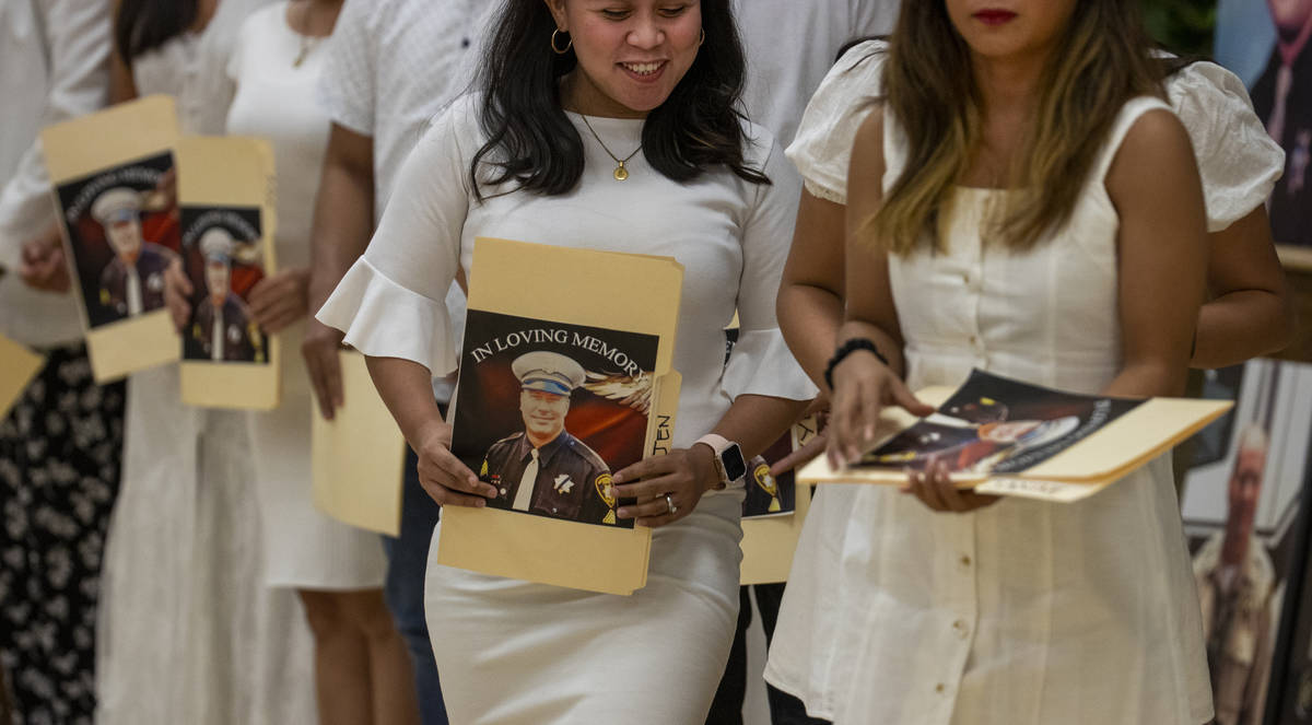 Members of the Filipino Teachers of Las Vegas walk off after singing a song during a public mem ...