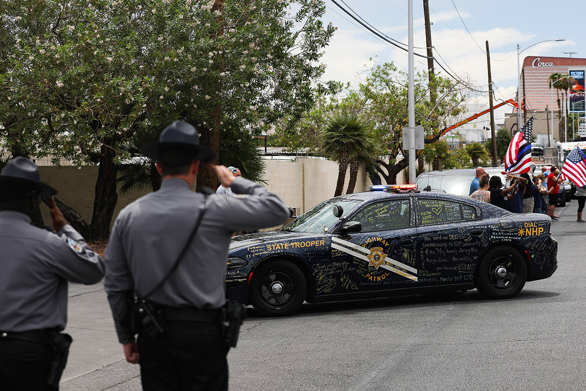 Nevada Highway Patrol troopers salute Nevada Highway Patrol Trooper Micah May's patrol car and ...