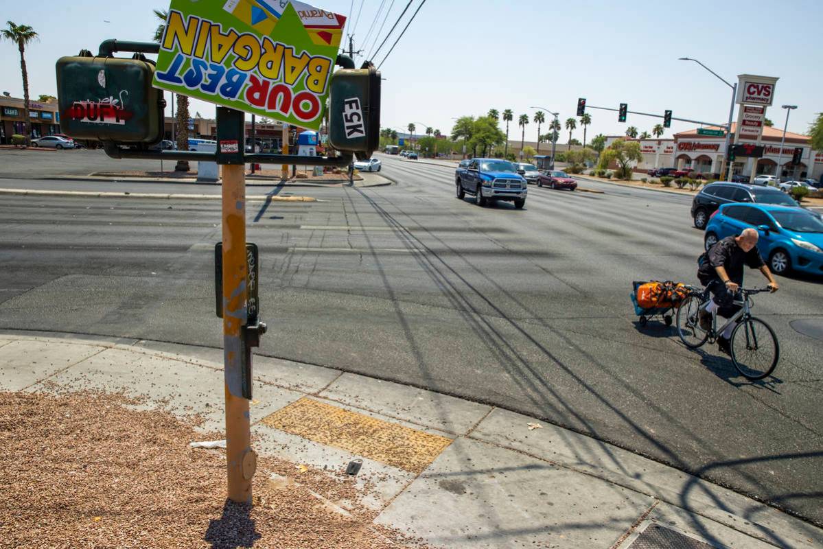 A cyclist rides through the intersection of North Lamb Boulevard and East Washington Avenue, wh ...