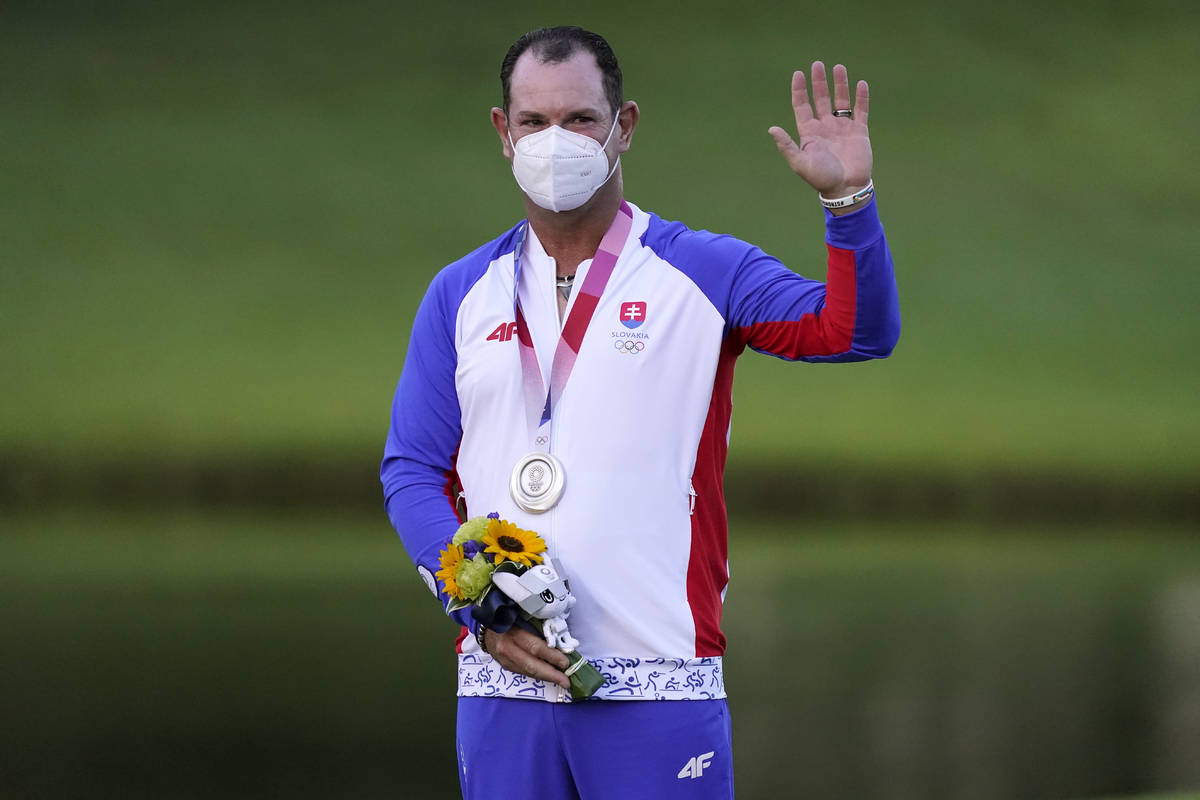 Silver medal winner Rory Sabbatini, of Slovakia, stands on the podium after the men's golf even ...