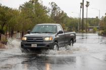 A truck navigates through high water about West Darby Avenue and South Blue Monaco Street. (L.E ...