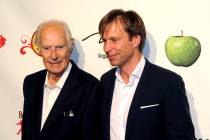 Music producers Sir George Martin, left, and son Giles Martin arrive for the fifth-anniversary ...