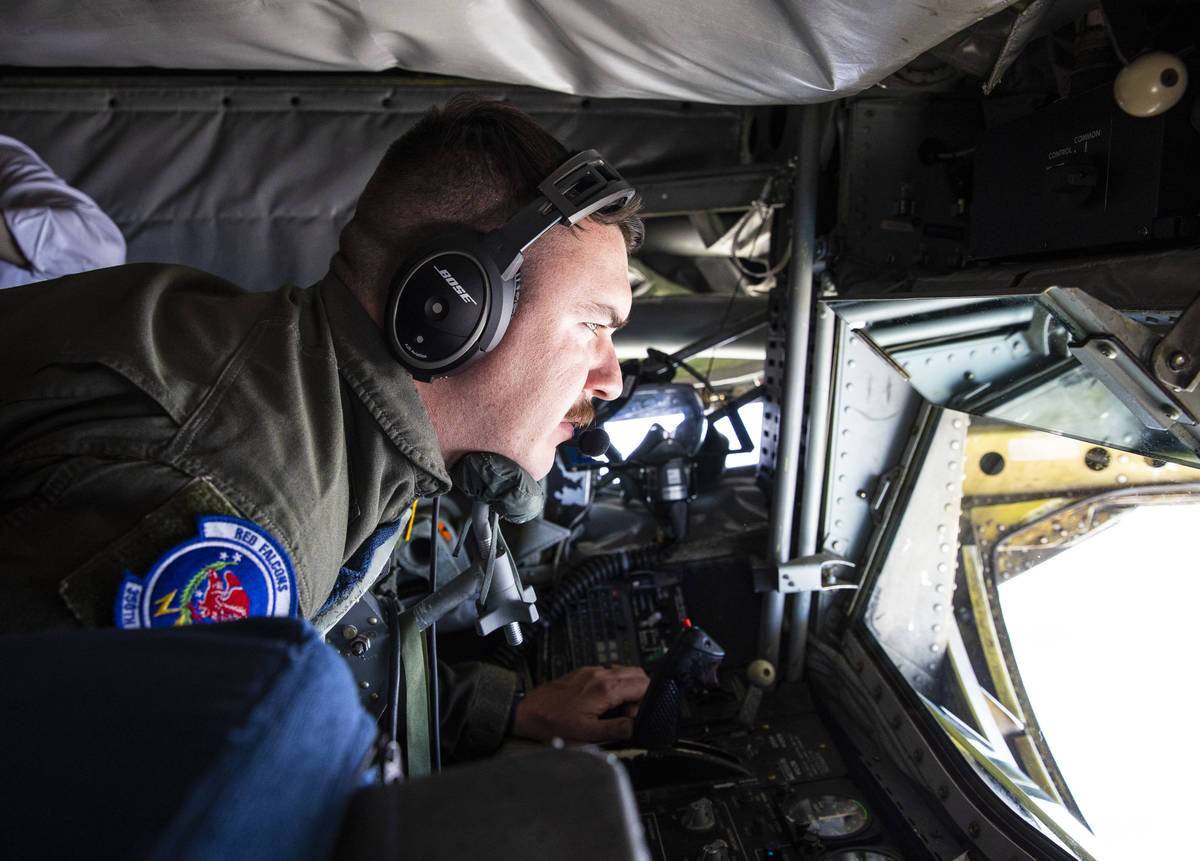 Staff Sgt. Jesse Lee, of the 350th Air Refueling Squadron, refuels an F-16 in-flight from the b ...