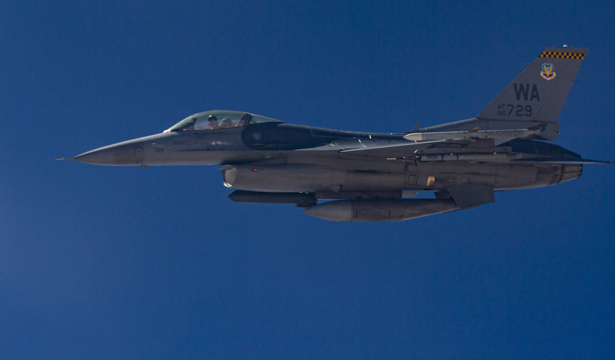 An F-16 flies alongside a KC-135 Stratotanker as it refuels planes around the Nevada Test and T ...