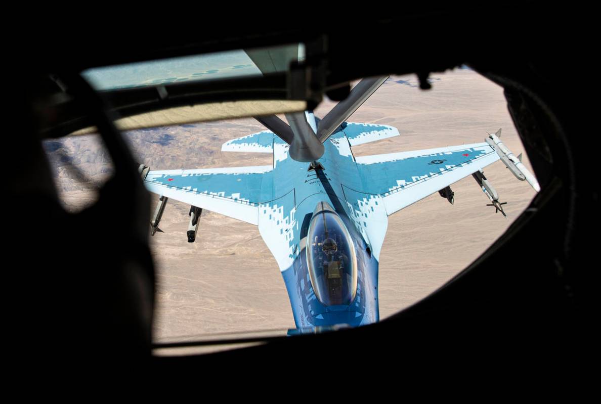 Staff Sgt. Jesse Lee, of the 350th Air Refueling Squadron, left, refuels an F-16 in-flight from ...