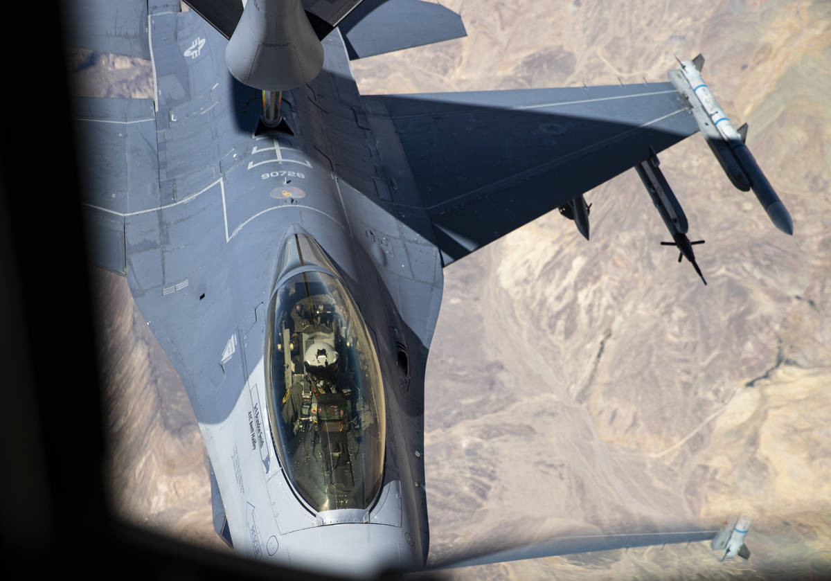 Airman first class Jonathon Covey, not pictured, operates the boom in order to refuel an F-16 i ...