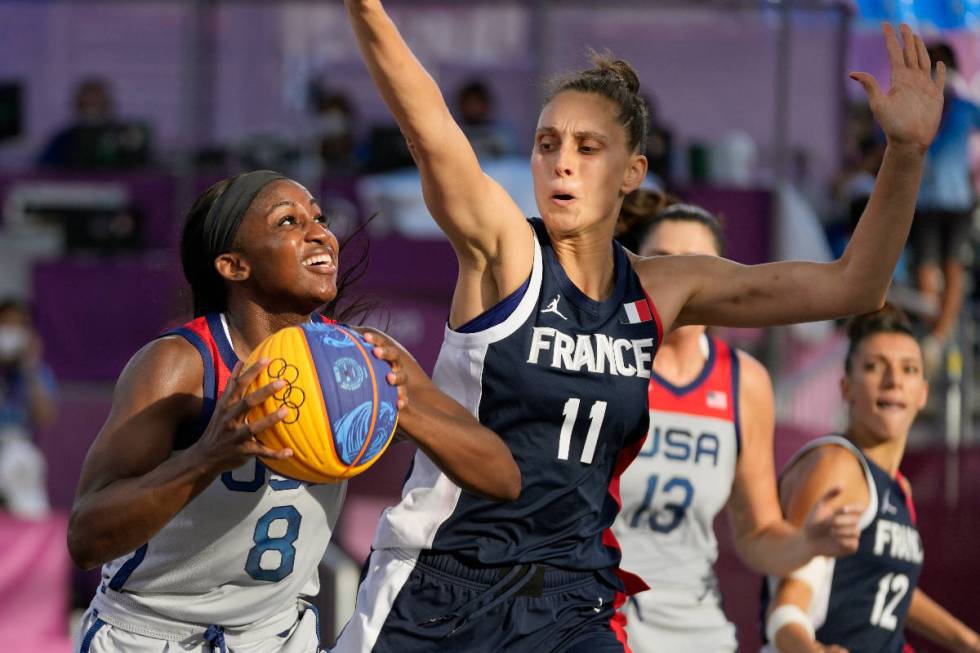 United States' Jackie Young (8) shoots over France's Ana Maria Filip (11) during a women's 3-on ...