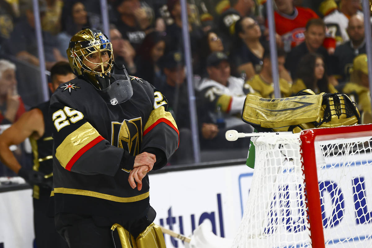 Golden Knights goaltender Marc-Andre Fleury (29) takes his gloves off during a break after givi ...