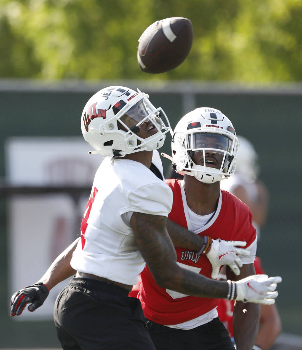 UNLV Rebels wide receiver Kilinahe Mendiola-Jensen (4) left, and UNLV Rebels defensive back Phi ...