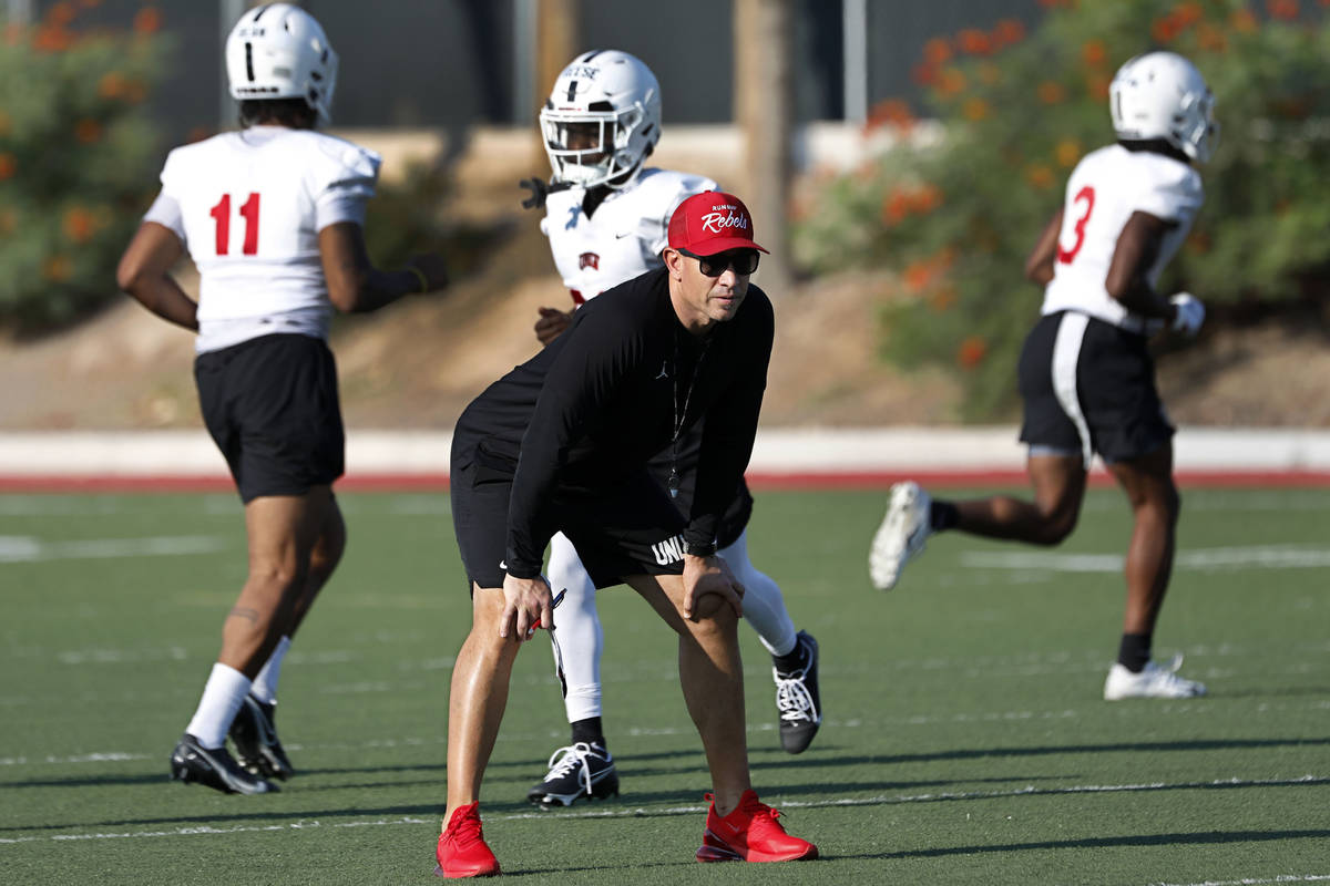 UNLV Rebels head coach Marcus Arroyo watches his players during football practice in UNLV, Wedn ...