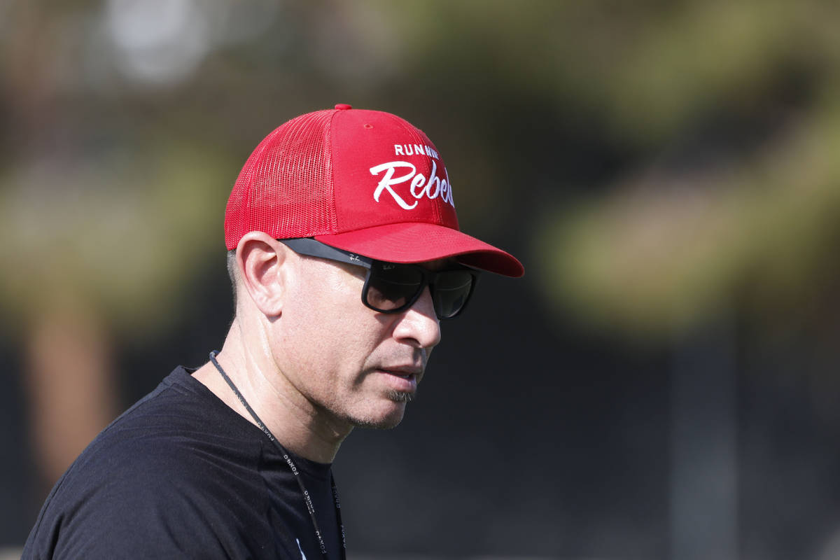 UNLV Rebels head coach Marcus Arroyo watches his players during football practice in UNLV, Wedn ...